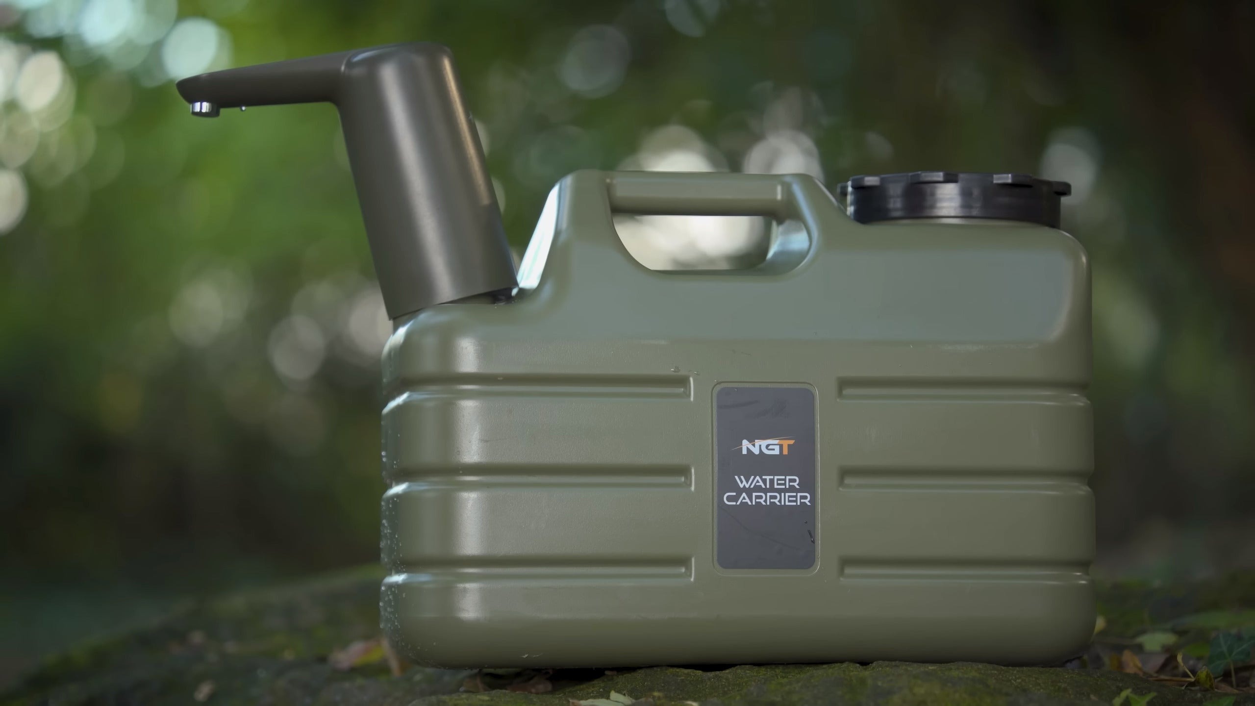 NGT Tackle Shop -Green water carrier with pump on a blurred natural background